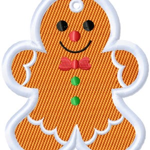May include: A gingerbread man design with a white outline and a textured orange body. The gingerbread man has black eyes, a red nose and bow tie, and green buttons. A small hole is at the top for hanging.