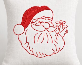 May include: A square white throw pillow featuring a red embroidered line art design of Santa Claus wearing a hat and holding a small gift. The embroidery shows a detailed beard, mustache, and a pom-pom on the hat, centered on the fabric.