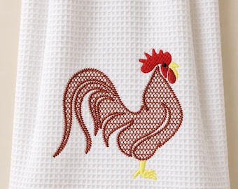 May include: A white waffle-weave kitchen towel featuring an embroidered rooster design. The rooster is rendered in shades of brown with a bright red comb and wattle, and yellow beak and feet. The embroidery has a cross-hatched texture pattern.