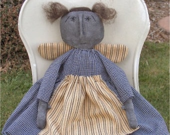 May include: A handmade rag doll with a black face, blue and white checkered dress, and a yellow and brown striped skirt. The doll is sitting on a white chair with the text "Chestnut Junction" printed on the bottom.