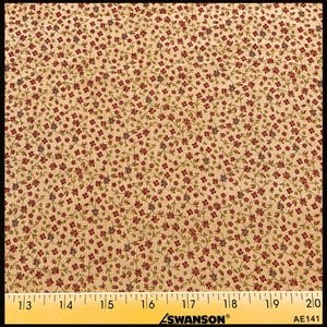 May include: A tan fabric featuring a dense, repeating pattern of tiny red flowers with green stems and leaves. A yellow Swanson ruler is positioned at the bottom, showing measurements from 13 to 20 inches across the width of the textile.