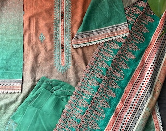 May include: A three-piece clothing set featuring a long-sleeved top with a gradient design in shades of orange and green, a pair of green pants, and a matching green dupatta with embroidered details.
