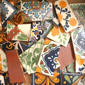 May include: Assortment of colorful, broken, ceramic tiles with intricate floral and geometric patterns. The tiles are in various shapes and sizes, with a mix of blue, green, yellow, orange, and red colors.
