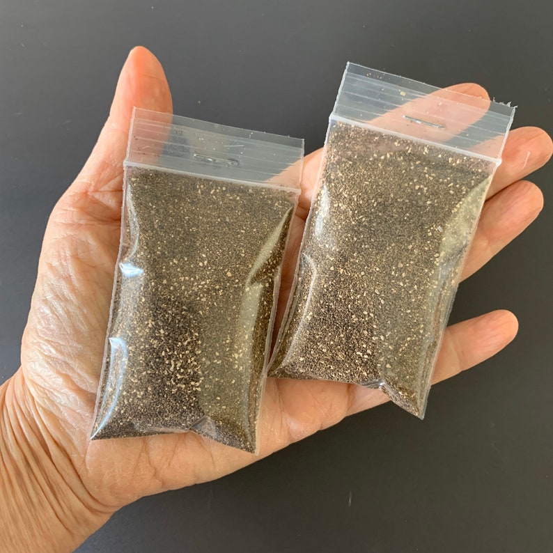May include: Two clear plastic bags filled with black peppercorns.