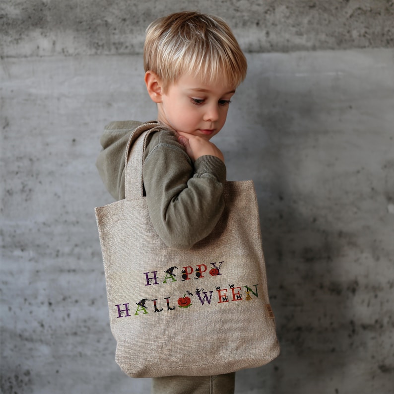 Halloween-themed cross stitch alphabet pattern with spooky decorated letters including pumpkins, witches, ghosts, cats, and bats – digital PDF for instant download