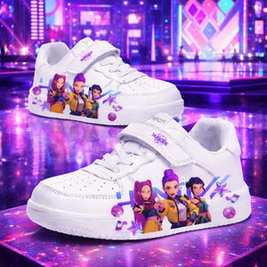 May include: White trainers with a hook-and-loop strap, featuring a colourful graphic of animated characters. The shoes have a perforated design and the word "FASHION" is printed on the side. The strap has the word "HARVIX" printed on it.