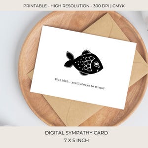 May include: A digital sympathy card featuring a black and white fish illustration, presented on a wooden tray with a brown envelope. The card reads "Blub blub... you'll always be missed." The card measures 17.78 x 12.7 cm.