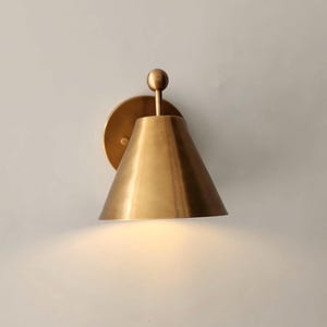 Side Profile of One Fixture Within a Handmade Brass Wall Sconce Pair, Showing the 9 Inch Projection, Decorative Finial, and Round Canopy. the Solid Brass Construction and Vintage Inspired Styling Create a Substantial yet Refined Wall Lighting Detail, Frost Lights.