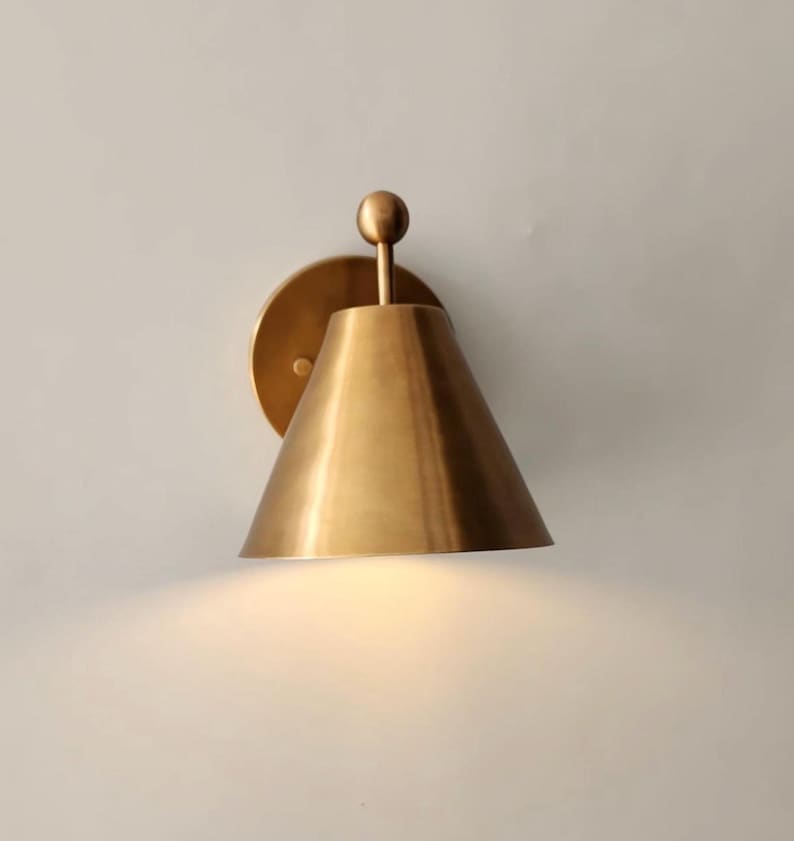 Side Profile of One Fixture Within a Handmade Brass Wall Sconce Pair, Showing the 9 Inch Projection, Decorative Finial, and Round Canopy. the Solid Brass Construction and Vintage Inspired Styling Create a Substantial yet Refined Wall Lighting Detail, Frost Lights.