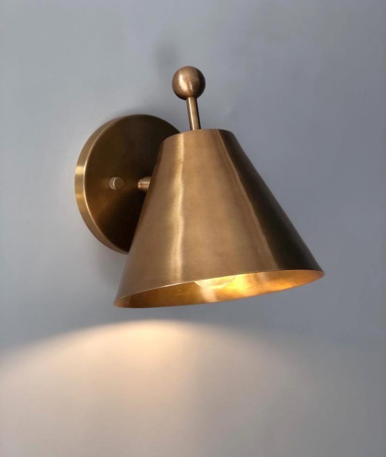 Front Perspective of A Handcrafted Brass Sconce Pair with Elegant Finial Detailing and Round Mounting Canopies. the Traditional Silhouette Combines Solid Brass Craftsmanship with A Warm Metallic Finish, Creating Coordinated Decorative Wall Lighting for Classic and Transitional Interiors, Frost Lights.