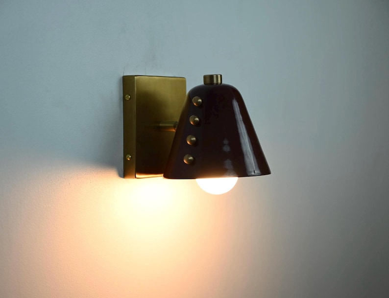 Close View of A Handmade Wine Shade Wall Lamp with A Cone Profile and Brass Detailing, Emphasizing the Deep Shade Color, Clean Silhouette, and Decorative Rivet Accents of This Distinctive Wall Fixture, Frost Lights.