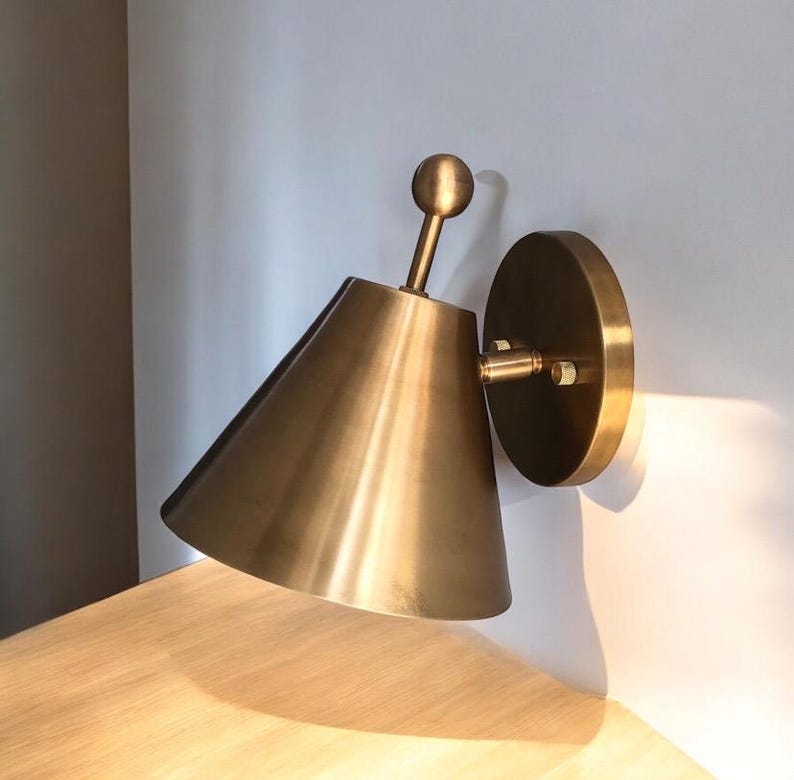Close-Up of The Carefully Finished Brass Surface and Finial Detailing on A Handcrafted Wall Light from This Coordinated Pair. the Decorative Form Adds Visual Interest to The Classic Silhouette While the Solid Brass Construction Gives the Fixture a Warm Artisan Character, Frost Lights.