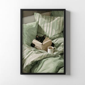 May include: A framed print depicts a black cat reading a book in bed. The cat is nestled among green and white striped bedding and pillows. A white mug of coffee sits nearby. The artwork has a cozy, relaxing theme.