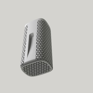 May include: A white cylindrical speaker with a geometric pattern on the front and sides. The speaker has a rectangular opening on the front.