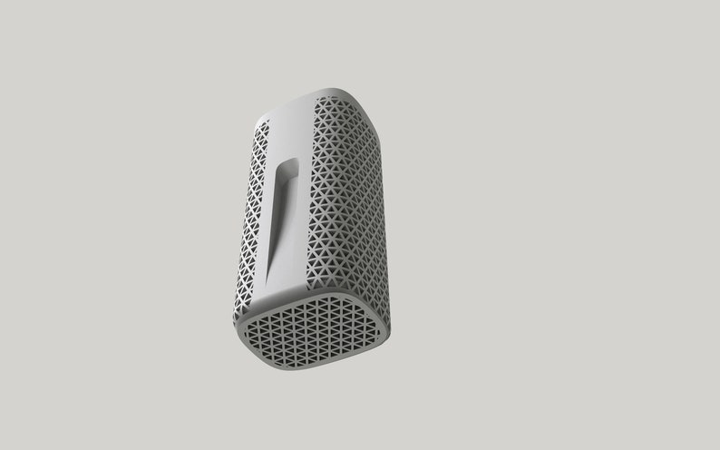 May include: A white cylindrical speaker with a geometric pattern on the front and sides. The speaker has a rectangular opening on the front.