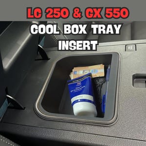May include: Black plastic tray insert for a car's centre console. The tray is designed to fit the centre console of a Lexus LC 250 or GX 550. The tray is shown with a tube of hand cream, a pen, and some cash inside.