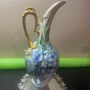 Antique Circa 1920 hand-painted porcelain 14” pitcher vase or ewer w/ blue floral/violet patterns and an ornate gold-leaf handle and spout