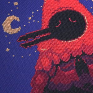 May include: A red and black pixel art cross-stitch design of a spaceship flying through a starry night sky. The spaceship has a round, black cockpit with two small windows and a long, black wing.