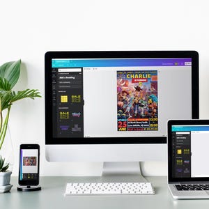 May include: A computer screen displaying the Canva website with a colorful poster design for a party called "Charlie's 25th Birthday." The poster features a cartoon image of a group of people. The screen is on a desk with a laptop and a smartphone also displaying the Canva website.