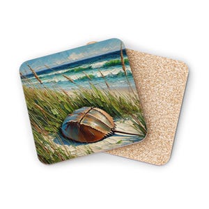 May include: A square coaster with a painting of a horseshoe crab on a sandy beach with green grass and blue ocean waves in the background.