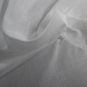 May include: Close-up of white fabric with a delicate, semi-sheer texture. The fabric is draped and folded, creating soft shadows and highlights. The material appears lightweight and breathable, suitable for clothing or home decor.