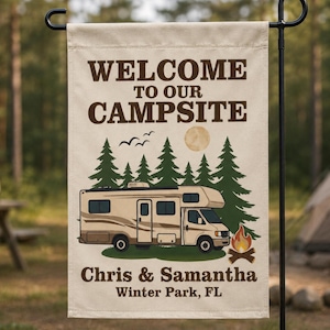 May include: A rectangular beige garden flag featuring the brown text WELCOME TO OUR CAMPSITE. The design includes a beige recreational vehicle, green pine trees, a yellow moon, black birds, and a campfire. The names Chris & Samantha and Winter Park, FL are printed in brown at the bottom.