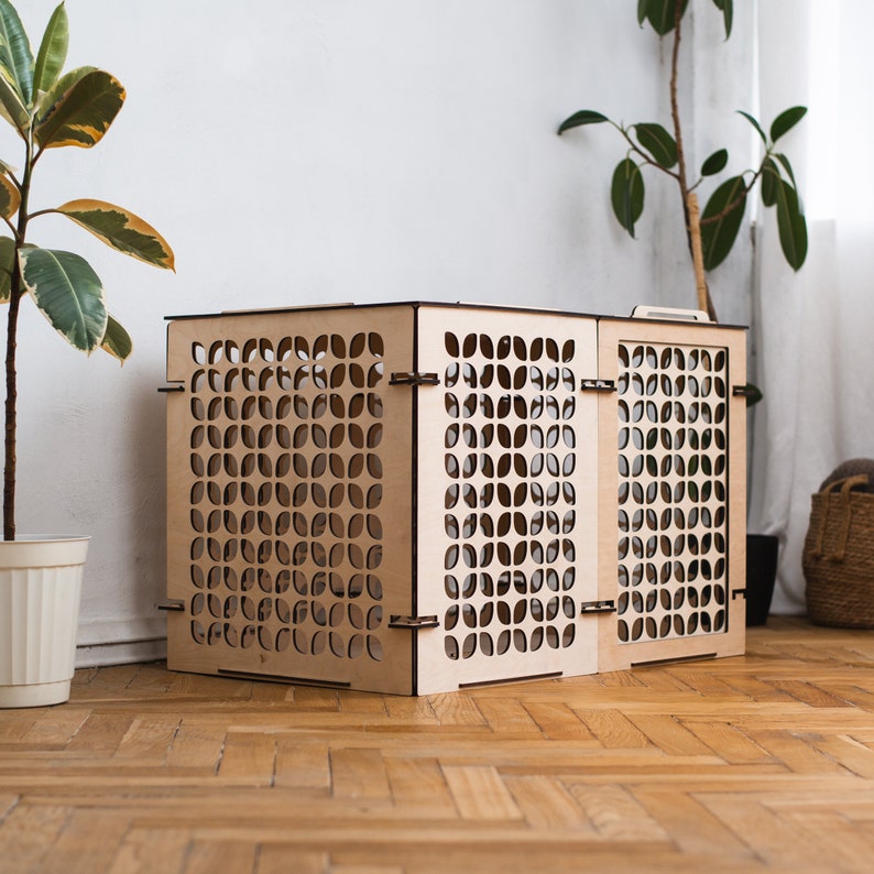May include: A light brown wooden pet gate with a geometric pattern. The gate is made of three panels that can be folded for storage.