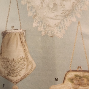 May include: Three vintage evening bags with chain straps. The top bag is white with lace trim. The middle bag is cream with a beaded tassel and floral embroidery. The bottom bag is cream with a floral design and a beaded trim.