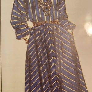 May include: A blue and white striped dress with a white collar and a gold belt. The dress has a chevron pattern on the skirt.