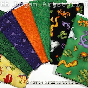 May include: A set of eight fabric squares featuring a desert-themed pattern with cacti, lizards, snakes, and skulls. The fabrics are in various colors, including green, orange, purple, and black.