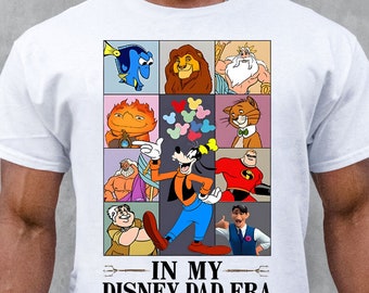 May include: White t-shirt with a collage of Disney characters, including Mickey Mouse, Goofy, Simba, and Nemo. The text "IN MY DISNEY DAD ERA" is printed below the collage.