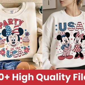 May include: Two white sweatshirts with red, white, and blue designs featuring Mickey Mouse and Minnie Mouse. One sweatshirt says "Party in the USA" and the other says "USA".