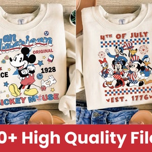 May include: Two cream-colored sweatshirts with a patriotic theme featuring Mickey Mouse and other Disney characters. The first sweatshirt has the text "an American" and "Mickey Mouse" with red, white, and blue accents. The second sweatshirt has the text "4th of July" and "Est. 1776" with red, white, and blue accents.