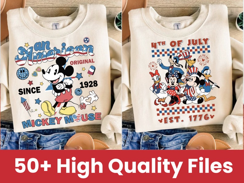 May include: Two cream-colored sweatshirts with a patriotic theme featuring Mickey Mouse and other Disney characters. The first sweatshirt has the text "an American" and "Mickey Mouse" with red, white, and blue accents. The second sweatshirt has the text "4th of July" and "Est. 1776" with red, white, and blue accents.