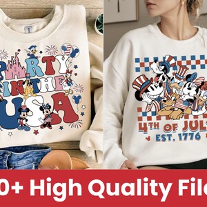 May include: Two white crewneck sweatshirts with red, white, and blue patriotic designs featuring Mickey Mouse and other Disney characters. The first sweatshirt says "Party in the USA" and the second sweatshirt says "4th of July Est. 1776".