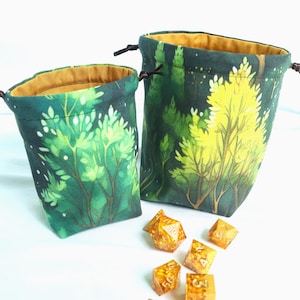 May include: A white ceramic mug with a black handle and the text "But First, Coffee" in a handwritten style. The mug is on a white surface. The mug is approximately 4 inches tall.