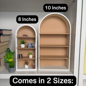 May include: Two white arched shelves with brown shelves. The smaller shelf is 8 inches wide and the larger shelf is 10 inches wide. The text "Comes in 2 Sizes." is below the shelves.