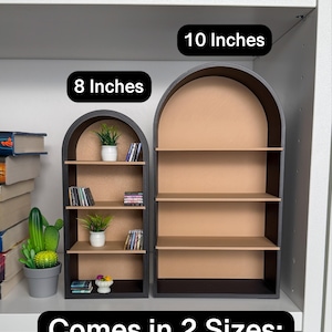 May include: Two black arched shelves with brown shelves. The smaller shelf is 8 inches wide and the larger shelf is 10 inches wide. The text "Comes in 2 Sizes" is at the bottom of the image.