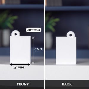 May include: A white rectangular tag with a rounded top and a hole for hanging. The tag is 1.9 cm wide, 2.5 cm tall, and 0.5 cm thick. The word "FRONT" is printed at the bottom of the tag.
