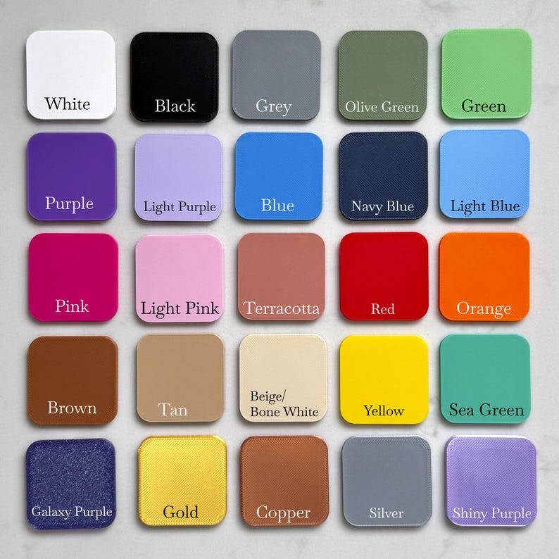 May include: A color palette featuring 25 square acrylic swatches in various colors. Colors include white, black, grey, olive green, green, purple, light purple, blue, navy blue, light blue, pink, light pink, terracotta, red, orange, brown, tan, beige/bone white, yellow, sea green, galaxy purple, gold, copper, silver, and shiny purple.