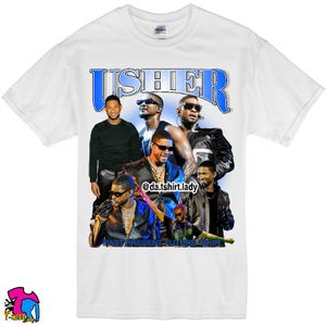 Può includere: Maglietta bianca con una grafica blu e bianca di Usher e il testo "USHER PAST PRESENT FUTURE TOUR" e l'account social "@da.tshirt.lady".