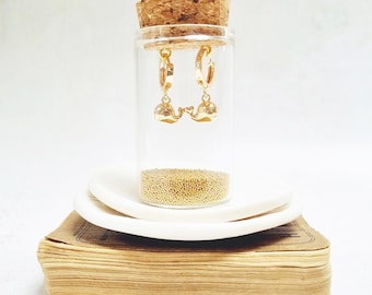 Gold Whale Huggie Earrings in a bottle