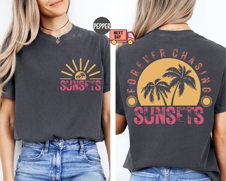 May include: Dark gray t-shirt with a sunset graphic on the front and back. The front features a sun and palm trees with the word "SUNSETS". The back says "FOREVER CHASING SUNSETS" with a similar design.
