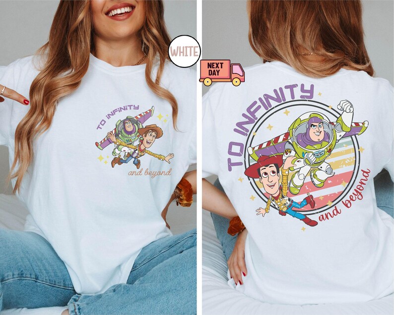May include: White t-shirt with a purple and blue graphic of Woody and Buzz Lightyear from Toy Story. The graphic says "To Infinity and Beyond".