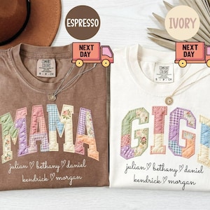 May include: Two Comfort Colors t-shirts, one espresso and one ivory, each with a patchwork design spelling "MAMA" and "GIGI". Below the names are the names "julian, bethany, daniel, kendrick, morgan". Each shirt has a necklace.