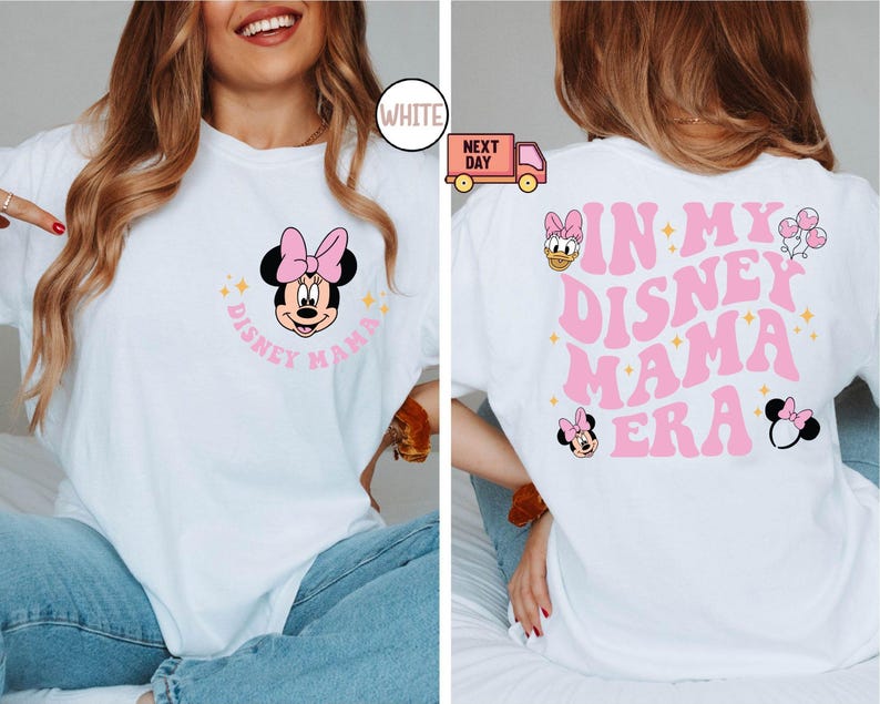May include: White t-shirt with a Minnie Mouse graphic on the front and the text "DISNEY MAMA". The back of the shirt features the text "IN MY DISNEY MAMA ERA" with additional Disney character graphics in pink.