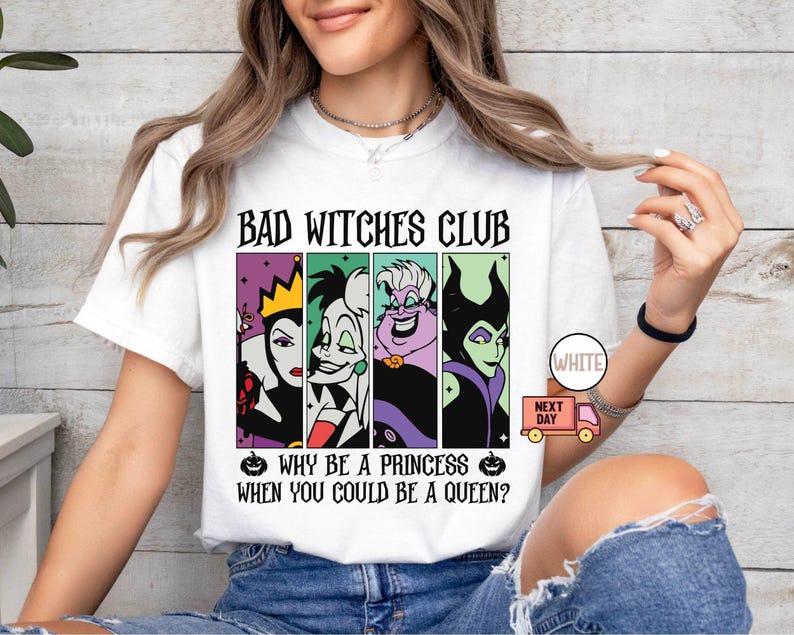 May include: White t-shirt with the text "BAD WITCHES CLUB" above four cartoon images of villainous characters. Below the images, the text reads "WHY BE A PRINCESS WHEN YOU COULD BE A QUEEN?" A small pumpkin graphic is on either side of the text.