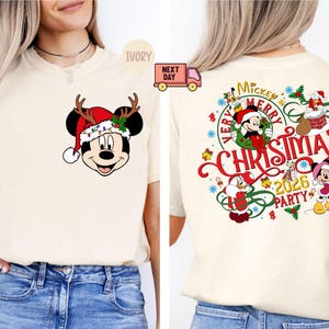 May include: A white ceramic mug with a black handle and the text "But First, Coffee" in a bold, black font. The mug is set against a blurred background, suggesting a cozy setting.