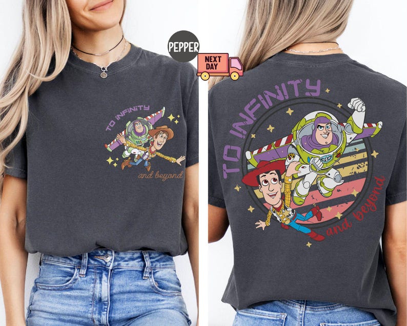 May include: A dark gray t-shirt with a graphic print of Woody and Buzz Lightyear from Toy Story. The graphic features the characters flying through space with the text "To Infinity and Beyond".