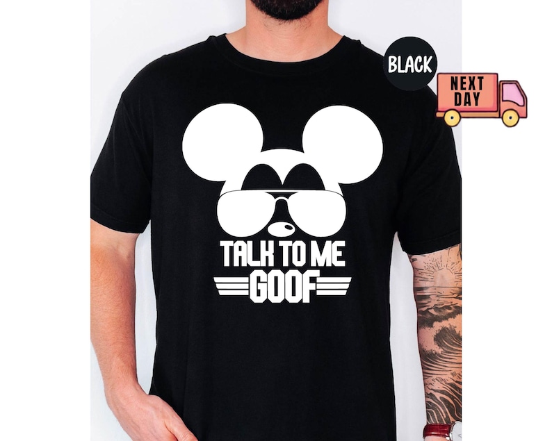May include: A black short-sleeved t-shirt featuring a large white graphic of a mouse silhouette wearing sunglasses. Below the graphic, the text reads TALK TO ME GOOF in bold white capital letters, flanked by two horizontal lines on each side.
